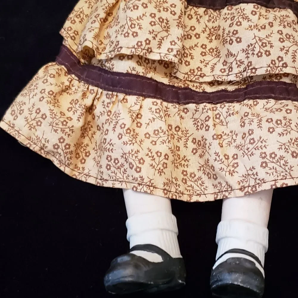 Vintage Porcelain Doll with Brown Dress and Hat